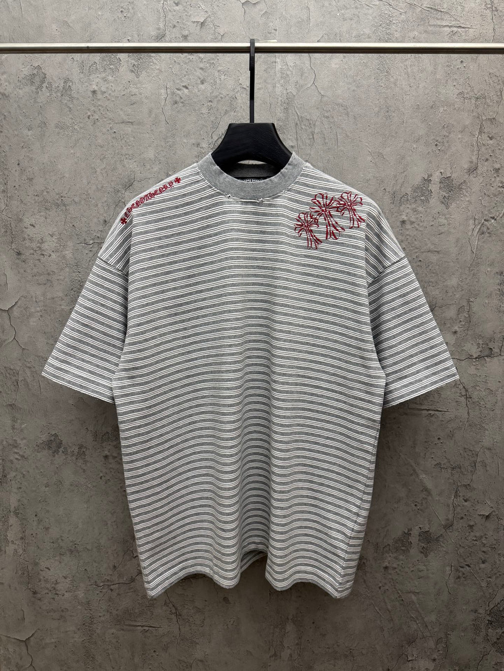 Striped short-sleeve T-shirt with red floral embroidery on chest, crew neck.
