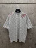 Striped short-sleeve T-shirt with red floral embroidery on chest, crew neck.