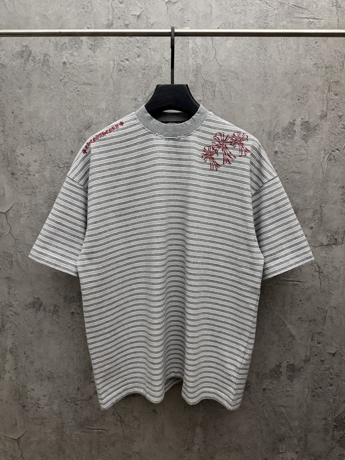 Striped short-sleeve T-shirt with red floral embroidery on chest, crew neck.