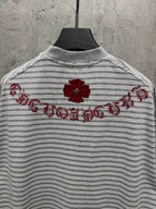 Striped short-sleeve T-shirt with red floral embroidery and script across upper back.