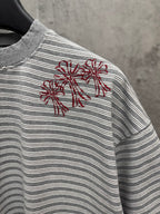 Striped short-sleeve T-shirt with red floral embroidery on left chest.