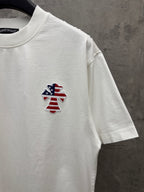 White short-sleeve T-shirt with small embroidered patriotic figure on chest