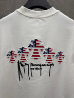 White T-shirt back with multiple embroidered patriotic figures and cursive text