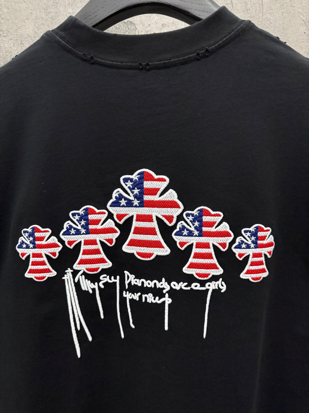 Black short-sleeve T-shirt with multiple USA angel graphic and drippy text