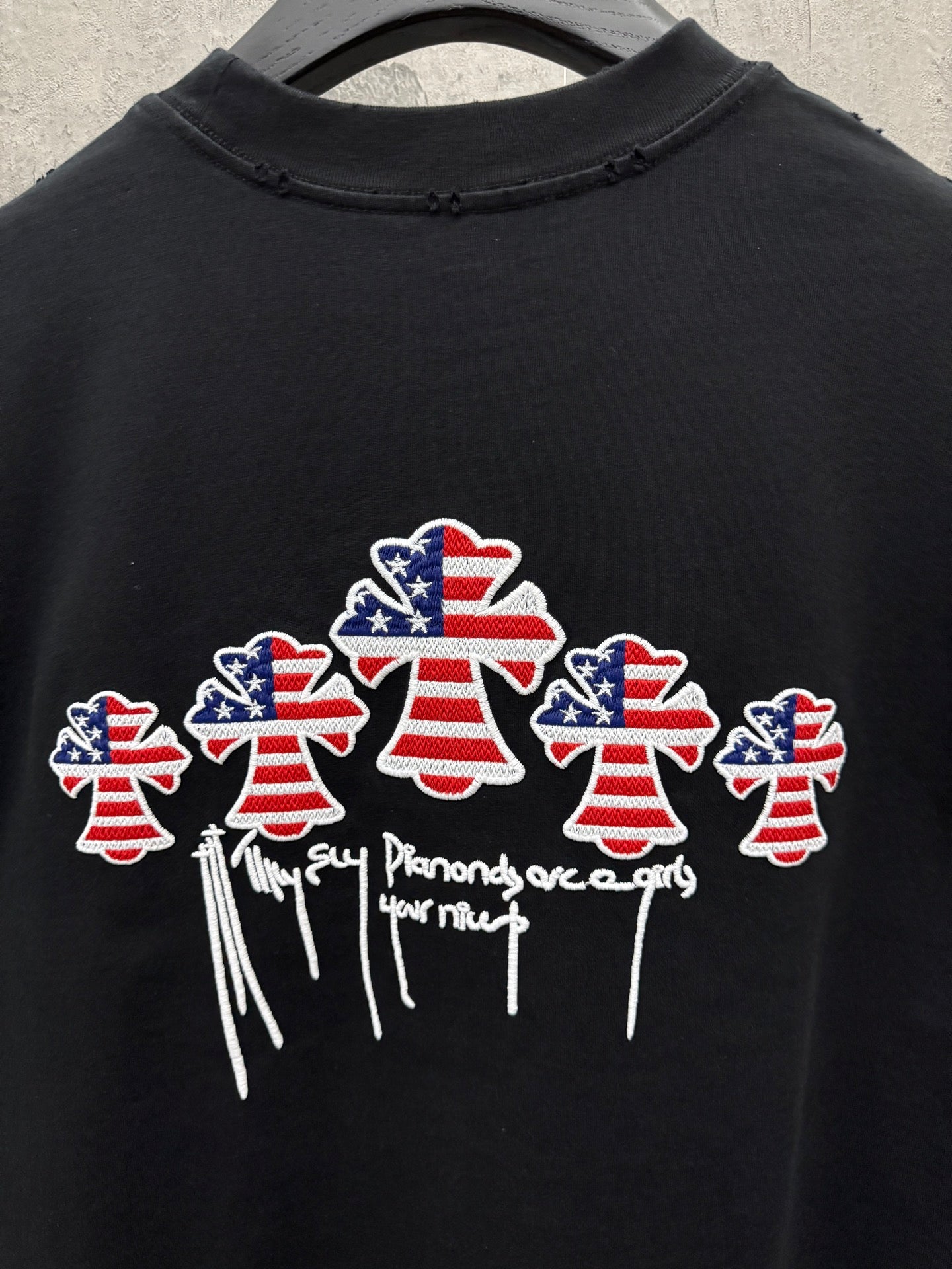Black short-sleeve T-shirt with multiple USA angel graphic and drippy text