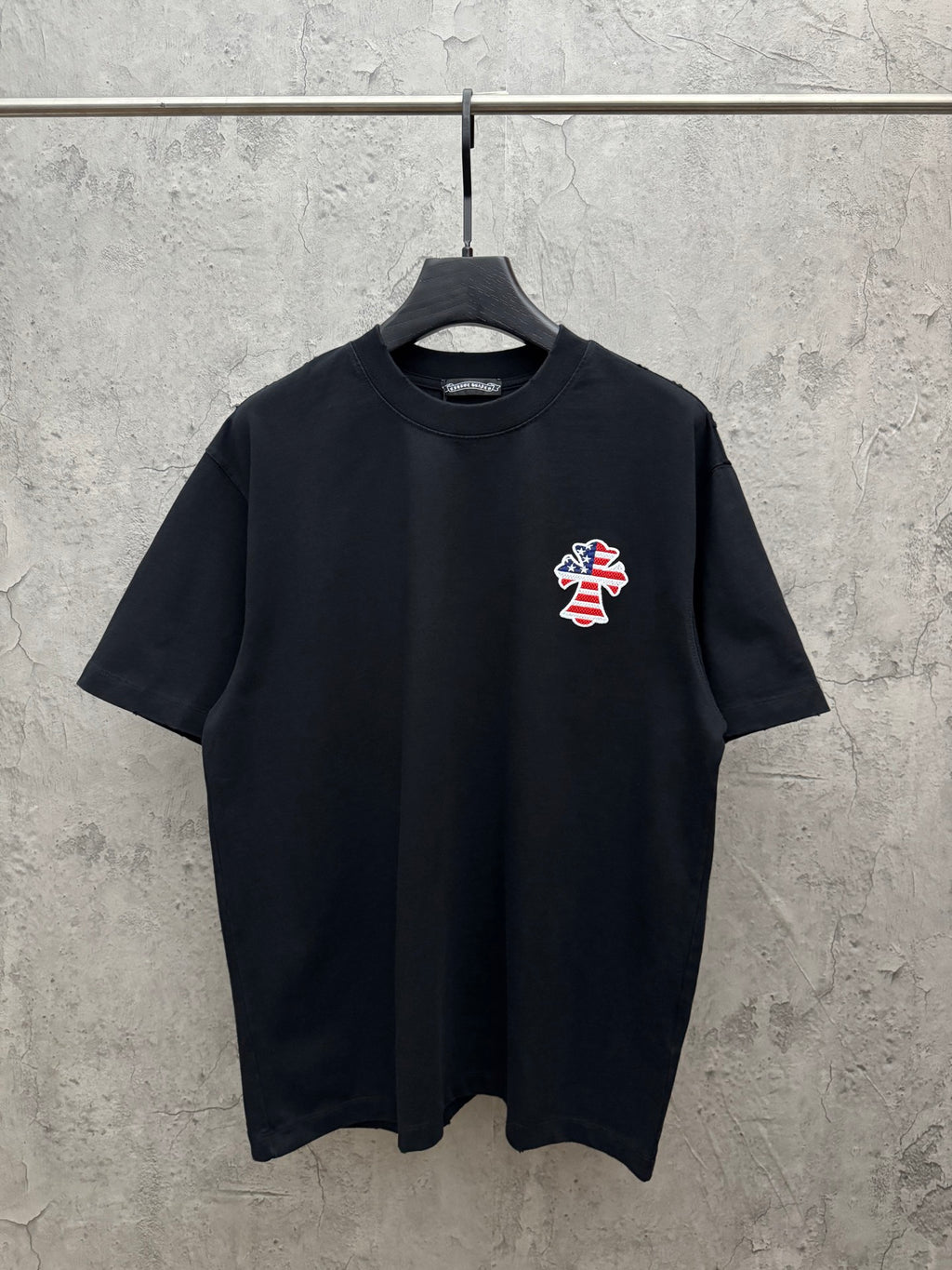 Black short-sleeve T-shirt with small USA angel graphic on the chest