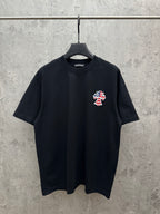 Black short-sleeve T-shirt with small USA angel graphic on the chest