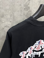 Side view of black T-shirt with partial USA angel graphic at the hem