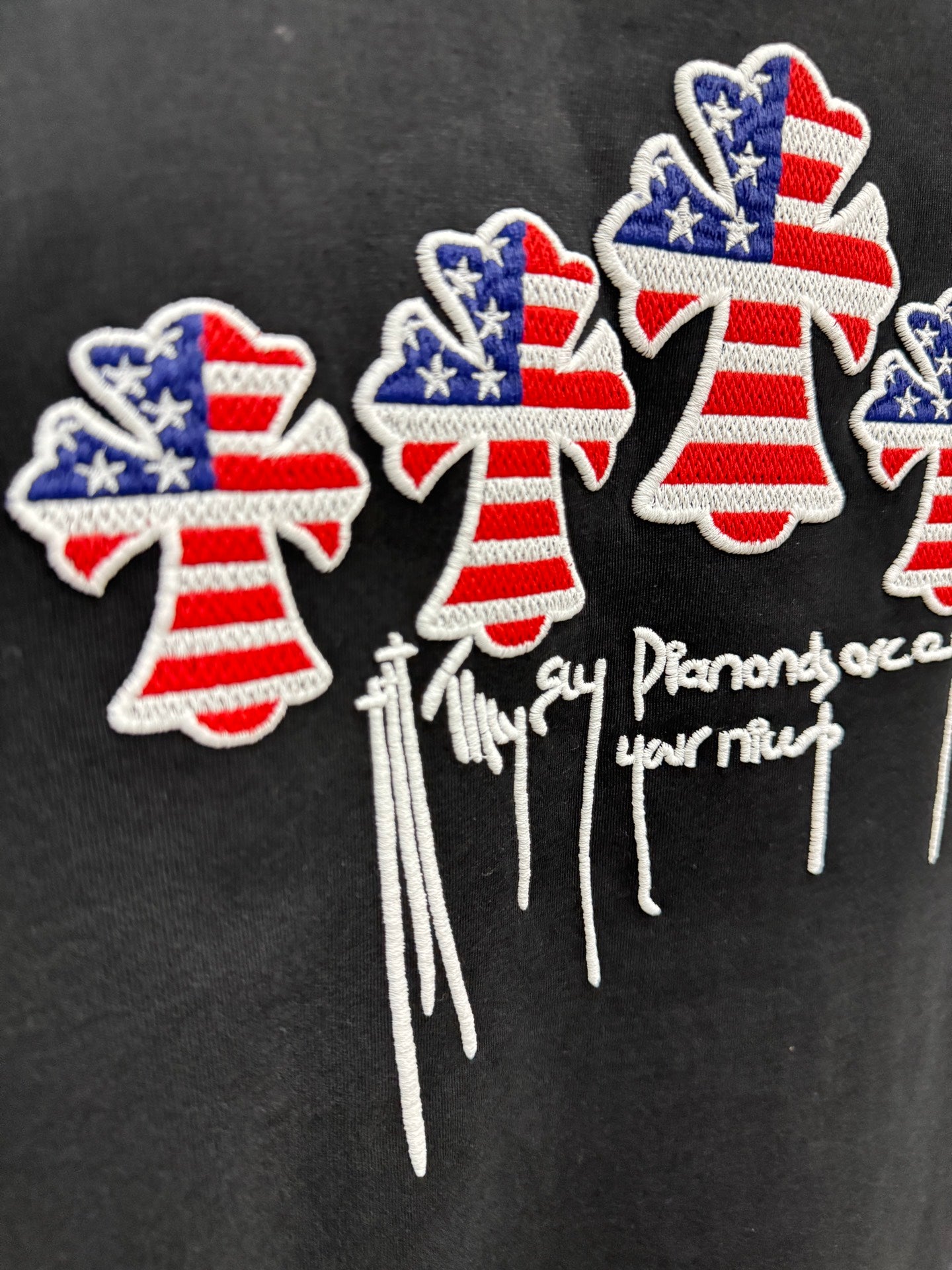 Embroidered USA angel cluster with drippy text on black T-shirt