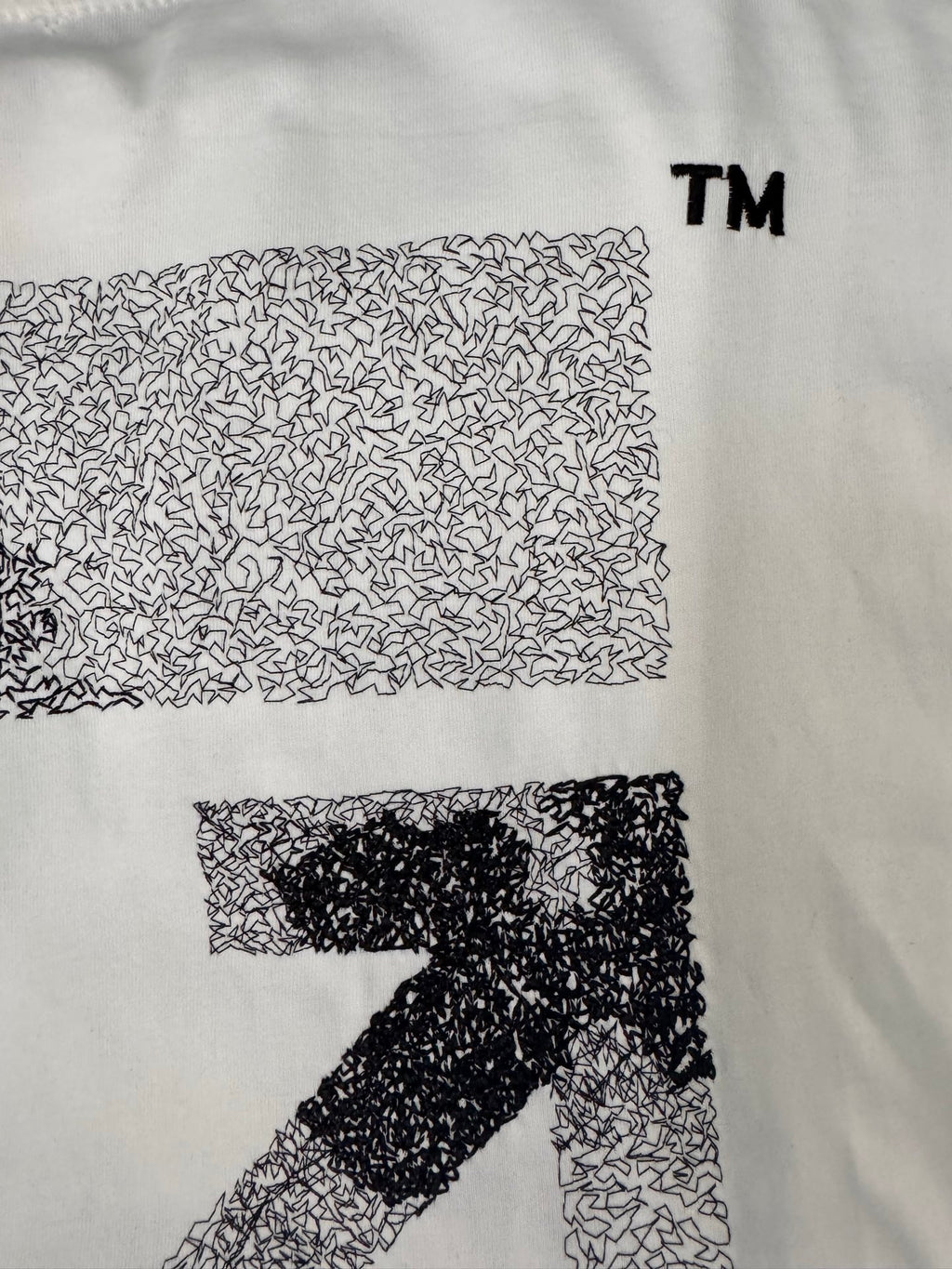 Off-white T-shirt with patterned block graphic and large number-style print