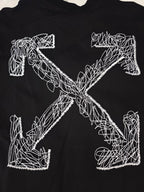Black T-shirt with large white line-art cross graphic on the front