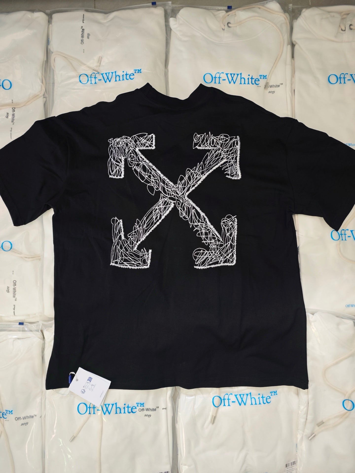 Black crewneck T-shirt with large white Off-White graphic lettering across the front