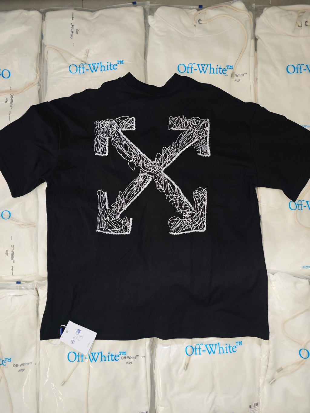 Black crewneck t-shirt with large white Off-White line-art graphic on the front.
