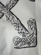 Off-White T-shirt front graphic close-up: black crossed arrow scribble