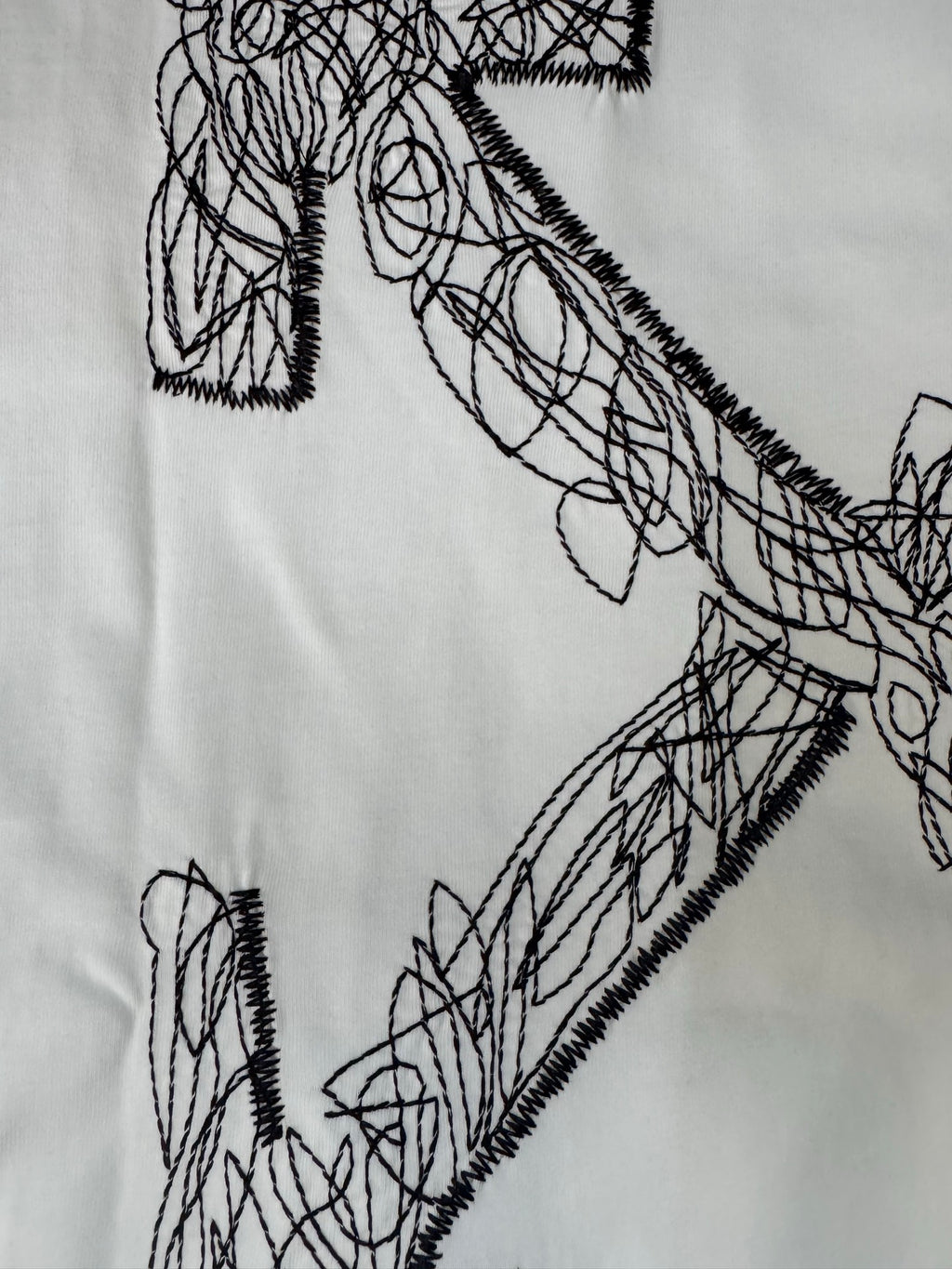 Off-White T-shirt front graphic close-up with black scribble lines