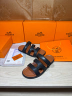 Hermes dark leather slide sandals with two thick strap bands, open toe