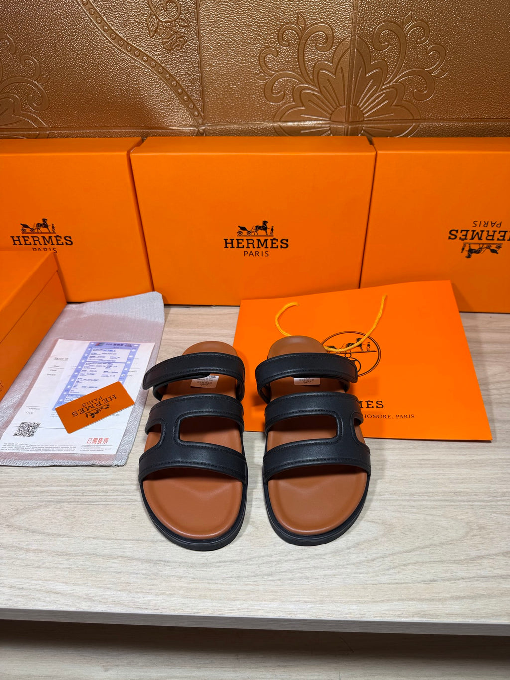 Hermes dark leather slide sandals with wide two-strap bands, flat sole