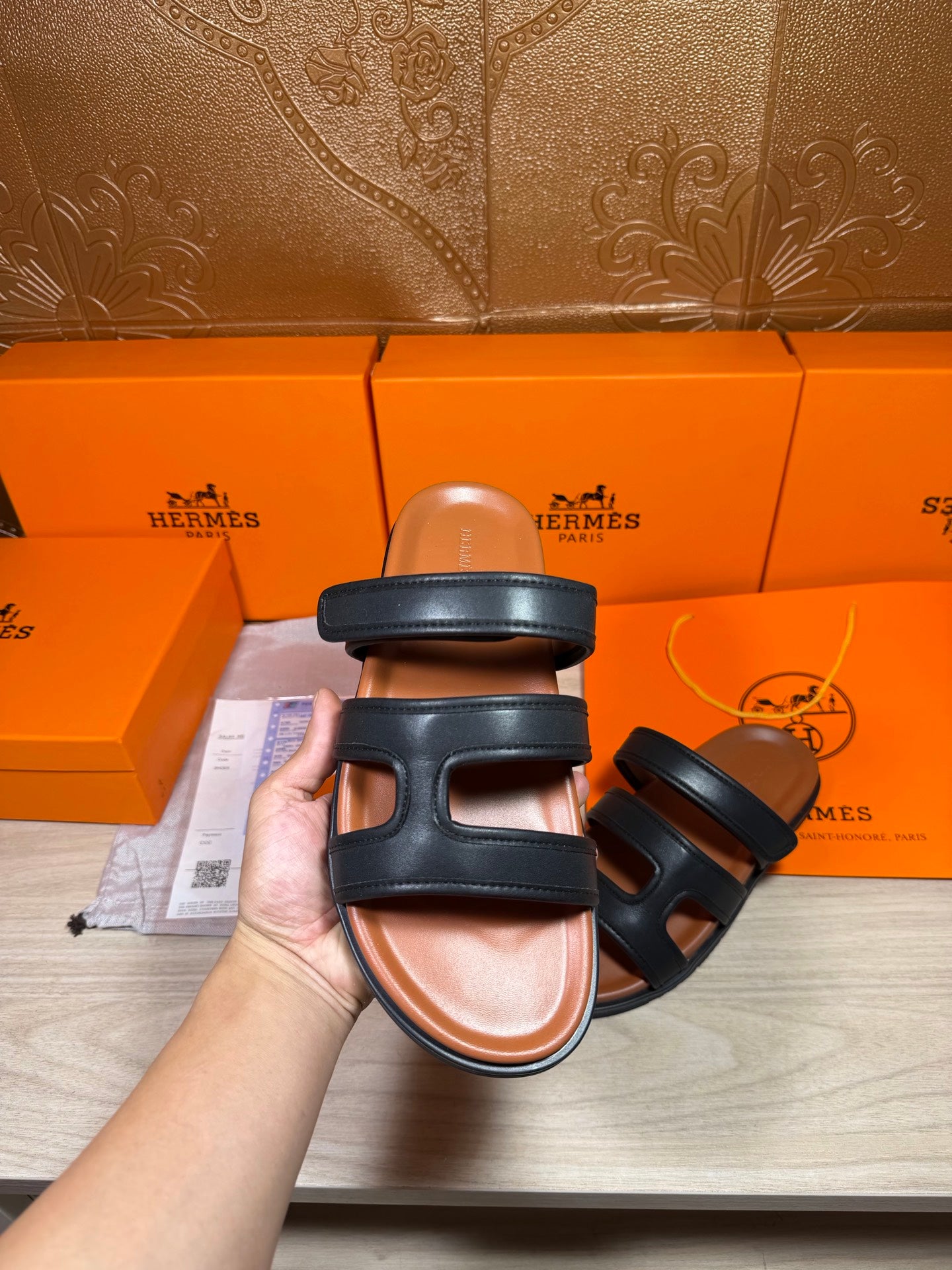 Hermes dark leather slide sandal with padded strap across top and open toe
