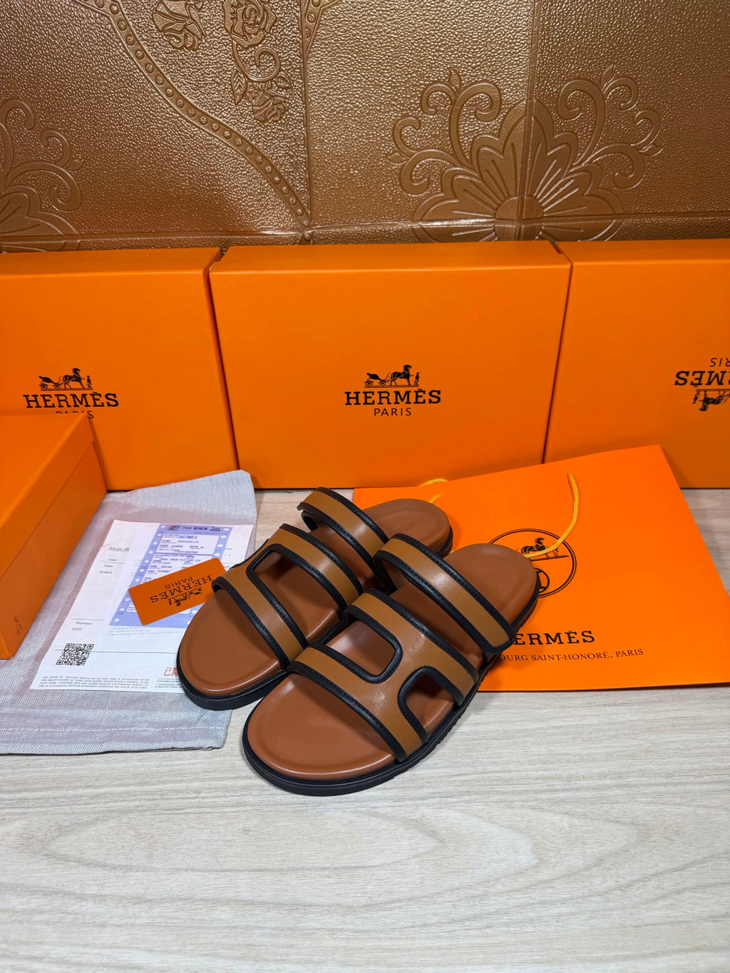 Hermes slide sandals, dark blue double-strap design with tan footbeds, side view