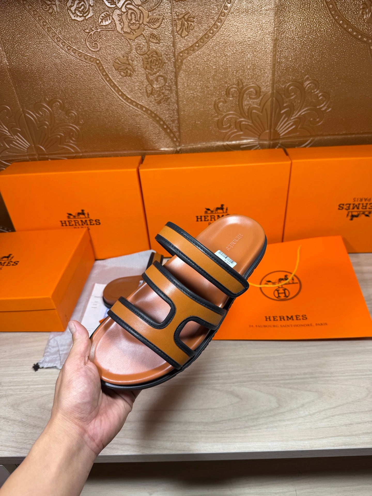 Hermes slide sandals held up, dark blue double straps with tan footbed