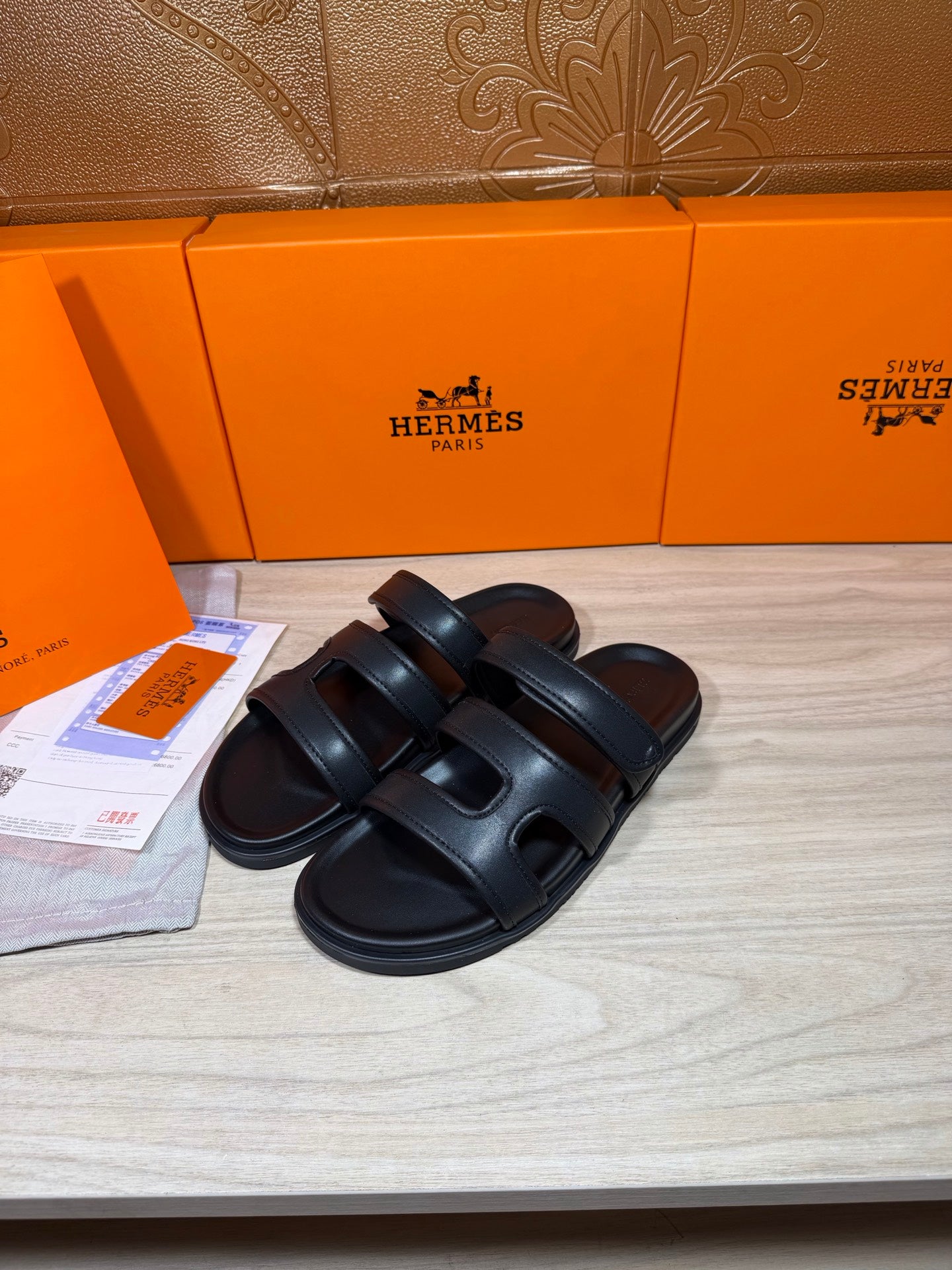 Hermes dark leather slide sandals with two wide cross straps and open toe design