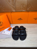 Hermes sandals in dark leather with wide two-strap upper and cushioned footbed