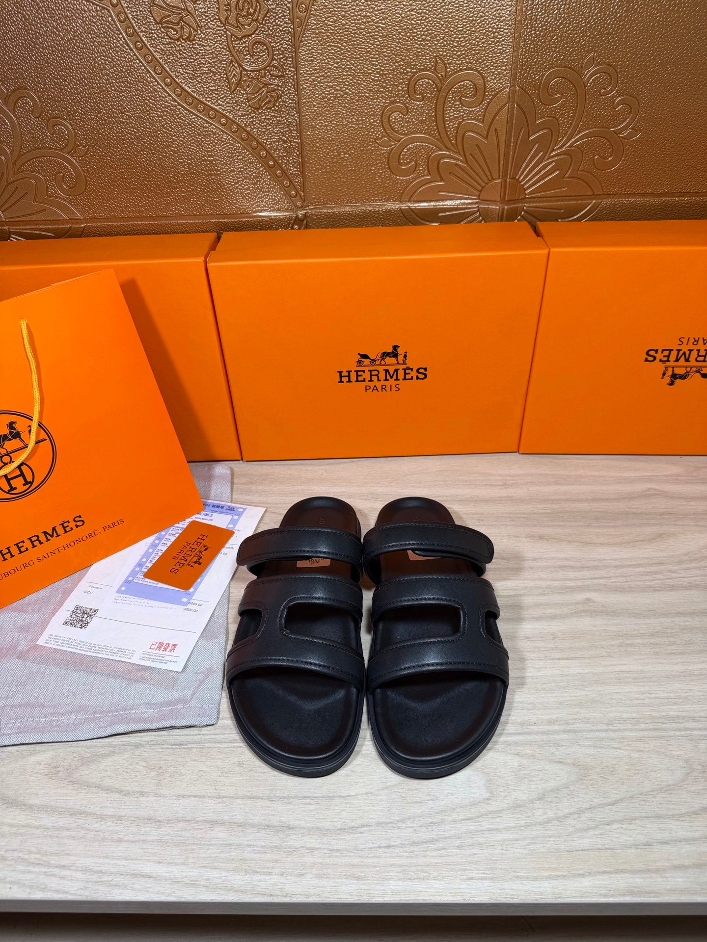 Hermes sandals in dark leather with wide two-strap upper and cushioned footbed
