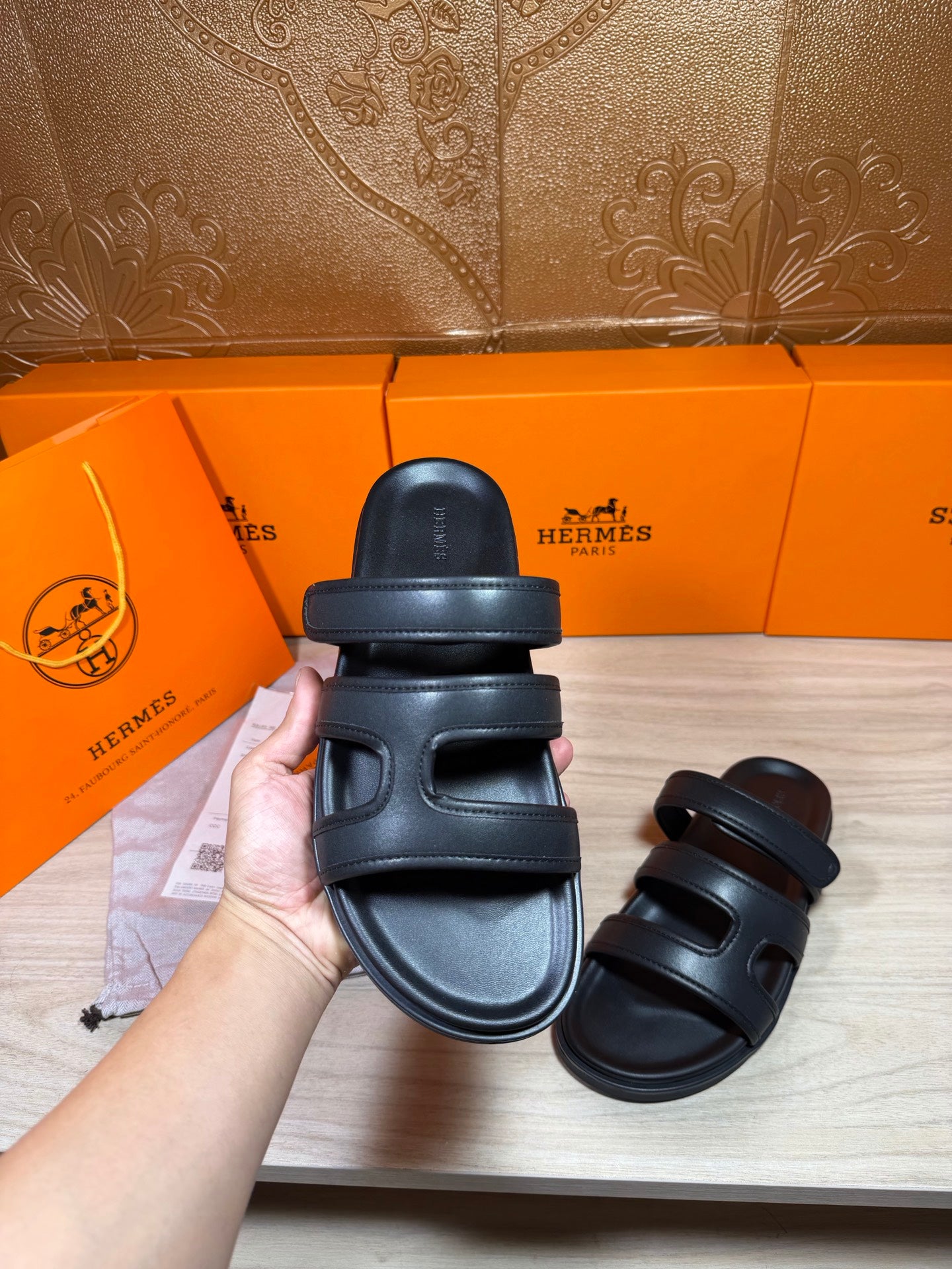 Hermes sandals in dark leather with two wide straps; heel strap and sole visible
