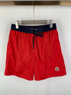 Moncler shorts in red with navy waistband and drawstring, side logo patch