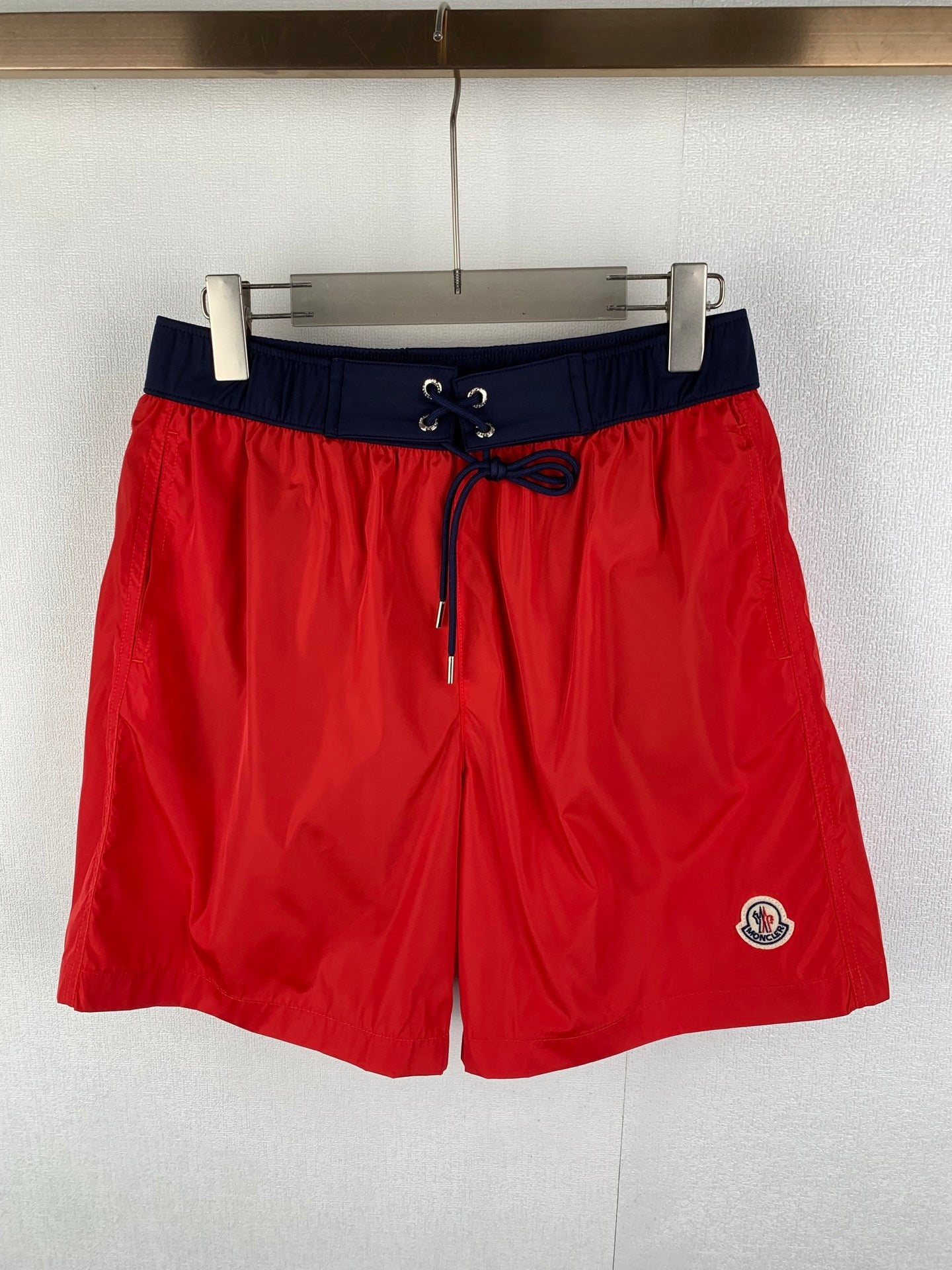 Moncler shorts in red with navy waistband and drawstring, side logo patch