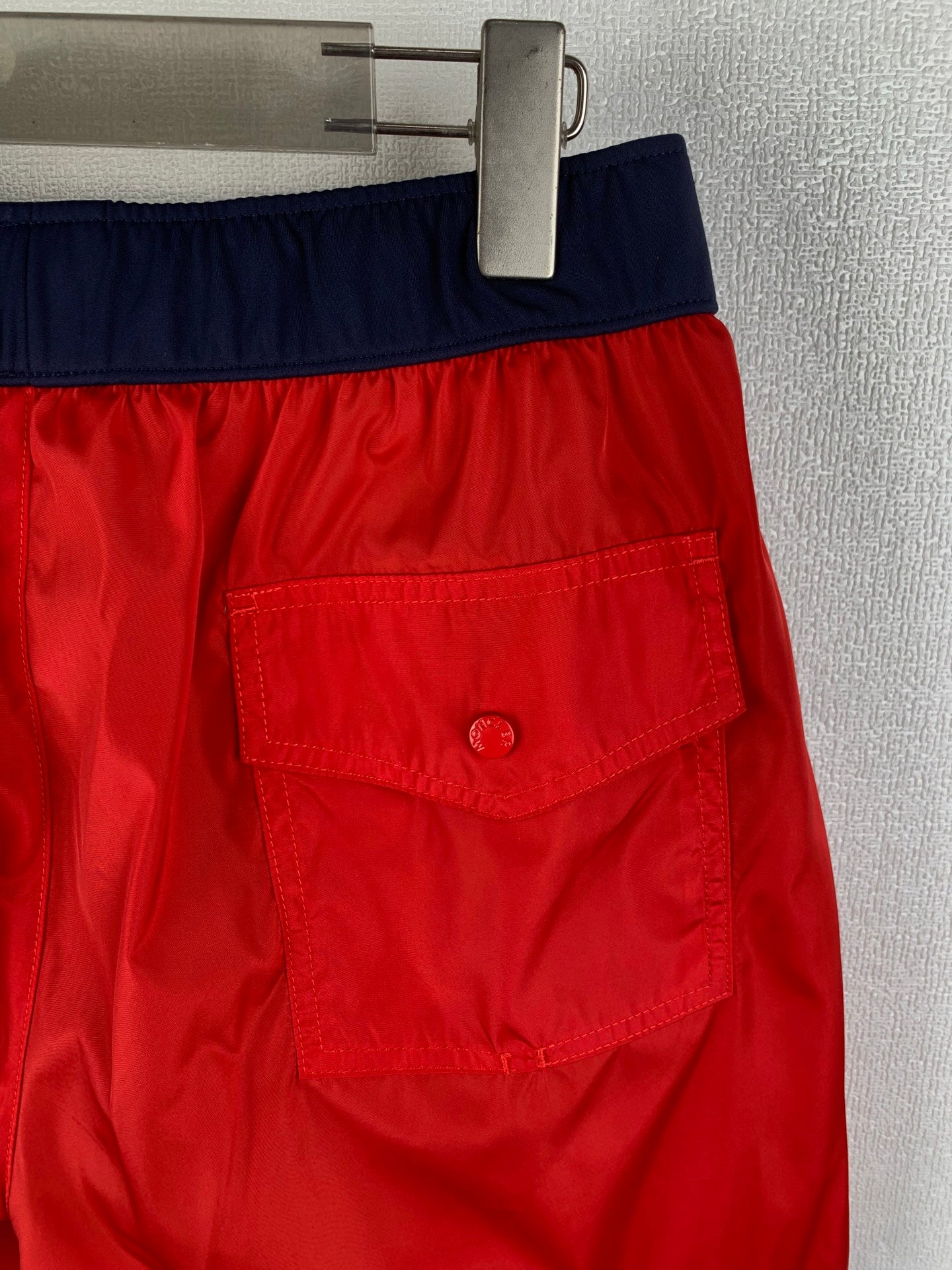 Moncler red shorts with navy waistband and stitched front patch pocket detail