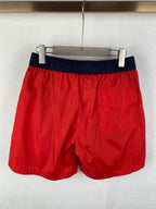 Moncler red shorts with navy waistband and front patch pocket