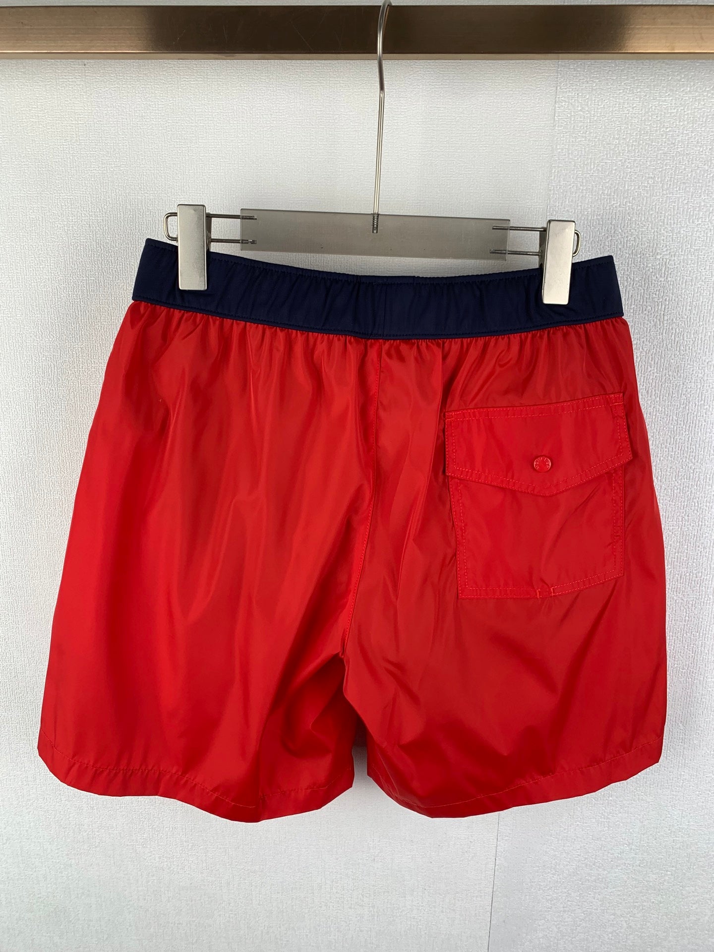 Moncler red shorts with navy waistband and front patch pocket