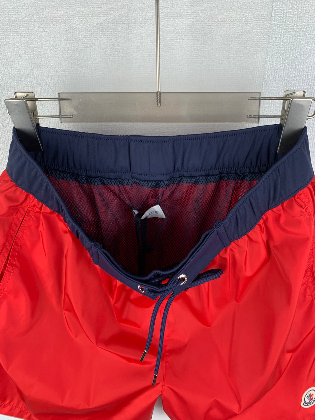 Red and navy pants with elastic waistband and drawstring at center front