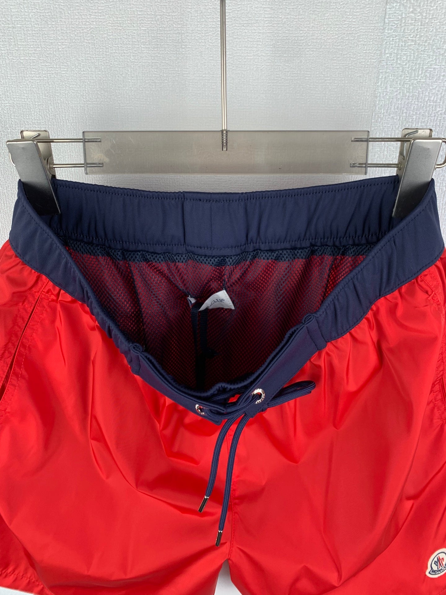 Red and navy pants with elastic waistband and drawstring at center front