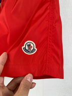 Moncler red shorts with round logo patch on the front leg