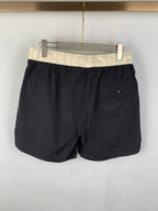 Moncler black swim shorts with cream waistband and front patch pocket