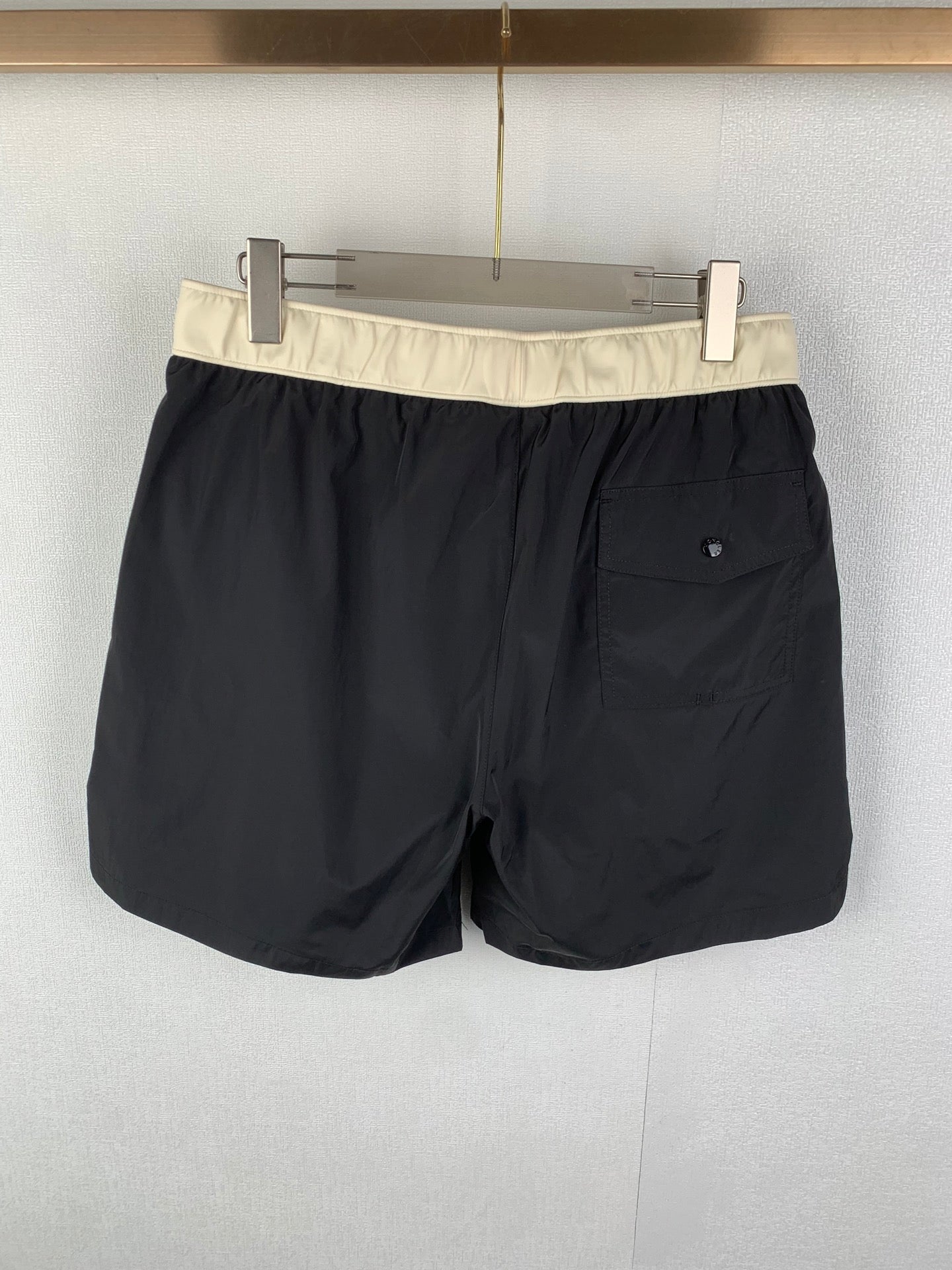 Moncler black swim shorts with cream waistband and front patch pocket