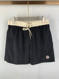 Moncler black swim shorts with cream drawstring waist and side logo patch