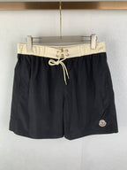 Moncler black swim shorts with cream drawstring waist and side logo patch