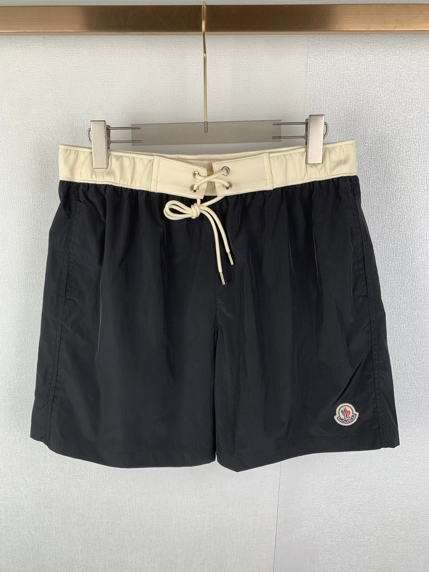 Moncler black swim shorts with cream drawstring waist and side logo patch