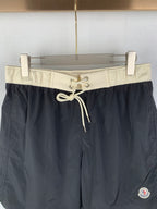 Moncler black swim shorts with cream waist band and tied drawstring