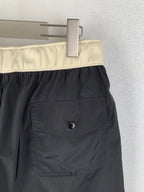 Moncler black swim shorts close-up of cream waistband and side pocket patch