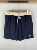 Moncler navy shorts-style pants with white drawstring waist and side pocket