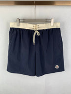 Moncler navy shorts-style pants with white drawstring waist and side pocket