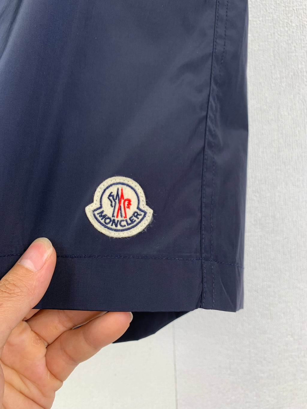 Moncler navy pants with embroidered round logo patch on side pocket area