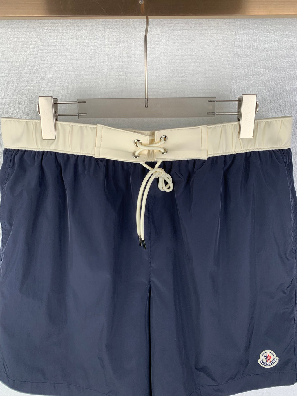 Moncler navy shorts-style pants with off-white elastic waistband and front drawstring