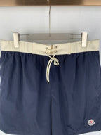 Moncler navy shorts-style pants with off-white elastic waistband and front drawstring