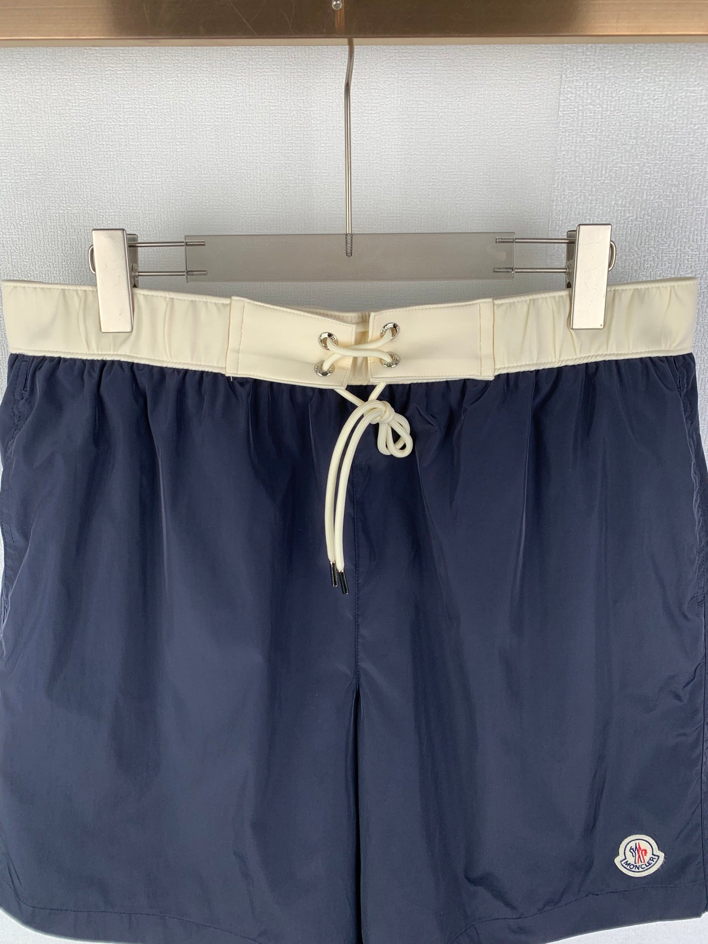 Moncler navy shorts-style pants with off-white elastic waistband and front drawstring