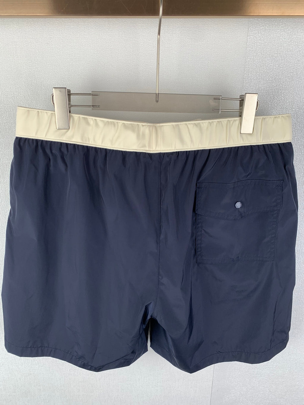 Moncler navy shorts-style pants with off-white waistband and front pocket detail